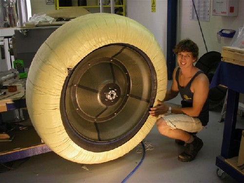 Clark crouched beside the first completed wheel for the PAC2