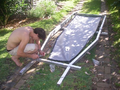 Clark tying the fabric flooring onto the PAC frame