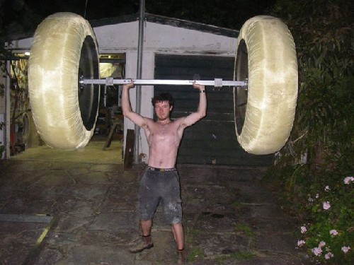 Chris holding up a completed PAC2 axle with finished wheels