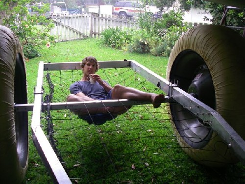Clark lazing back in the bag-netting, sipping a mug of tea