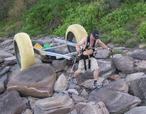 Chris hauling the PAC2 over some pretty serious boulders