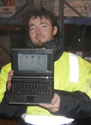 Chris holding up the cool little Asus Eee PC laptop in the warehouse freezer