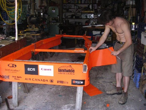 Chris putting sponsor banner on PAC