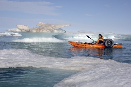 Clark paddling past beautiful icebergs