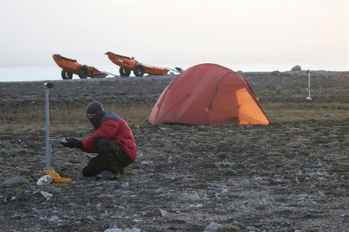 Setting up our polar bear tripwire around the tent to give us warning of hungry bears