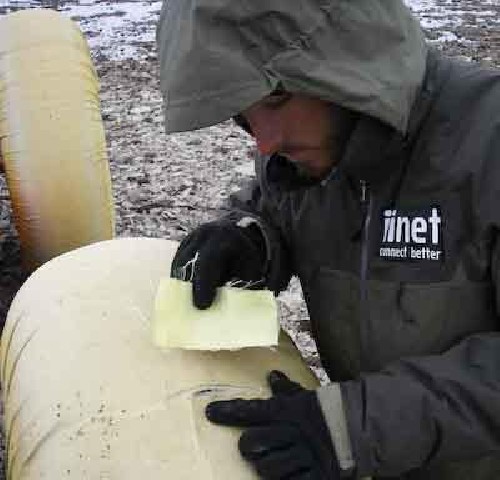 Chris about to put a Kevlar patch behind a tear in the PAC wheel covers