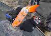 Unbolting the warped axel, which we then cut shorter. - Click for full-size.