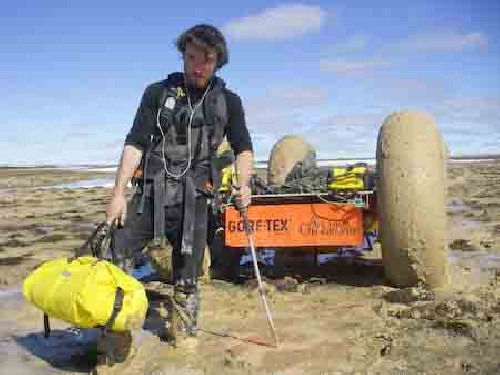 Chris portaging Ortlieb drybags one at a time to lighten PAC to de-bog in mud - Click for full-size.