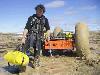 Chris portaging Ortlieb drybags one at a time to lighten PAC to de-bog in mud - Click for full-size.