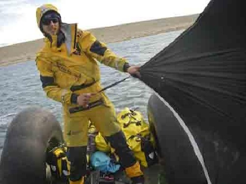 Clark holding up our tent vestibule as a sail for HMAS Nugget