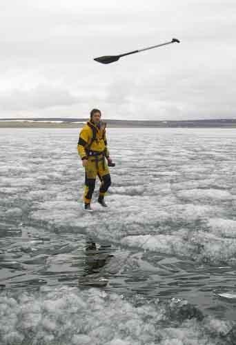 A paddle being flung to Clark to assist his ice-hop across the lead
