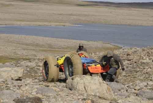Tediously lowering the PAC down a hill of boulders
