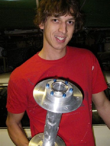 Clark holds up a newly assembled wheel hub