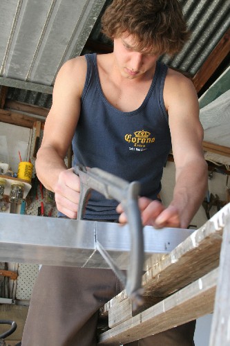 Clark hacksawing aluminium load arms for PAC2