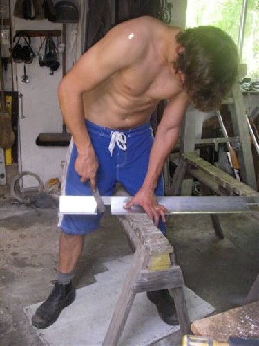 Clark filing the spacer bar between the load arms