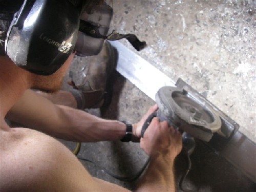 Chris circular-sawing a length of the aluminium load arm