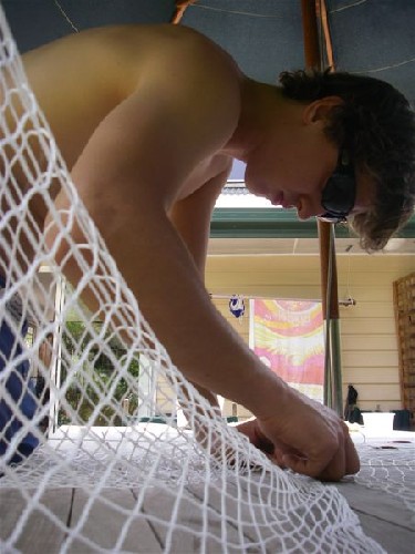 Clark painstakingly stitching together netting
