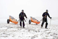 Chris and Clark hauling their PACs over the snow