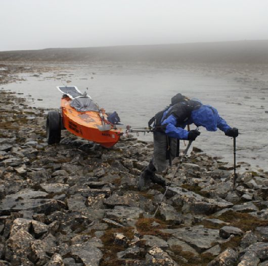 Clark hauling beside river in Gore-Tex Jacket