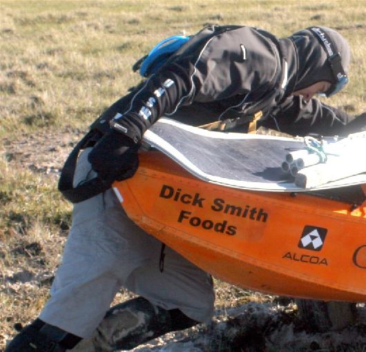 Clark pushing his cart out of a mud pit, 2005
