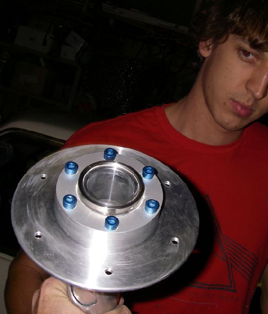 Clark holding up PAC hub with blue Hyperbolts